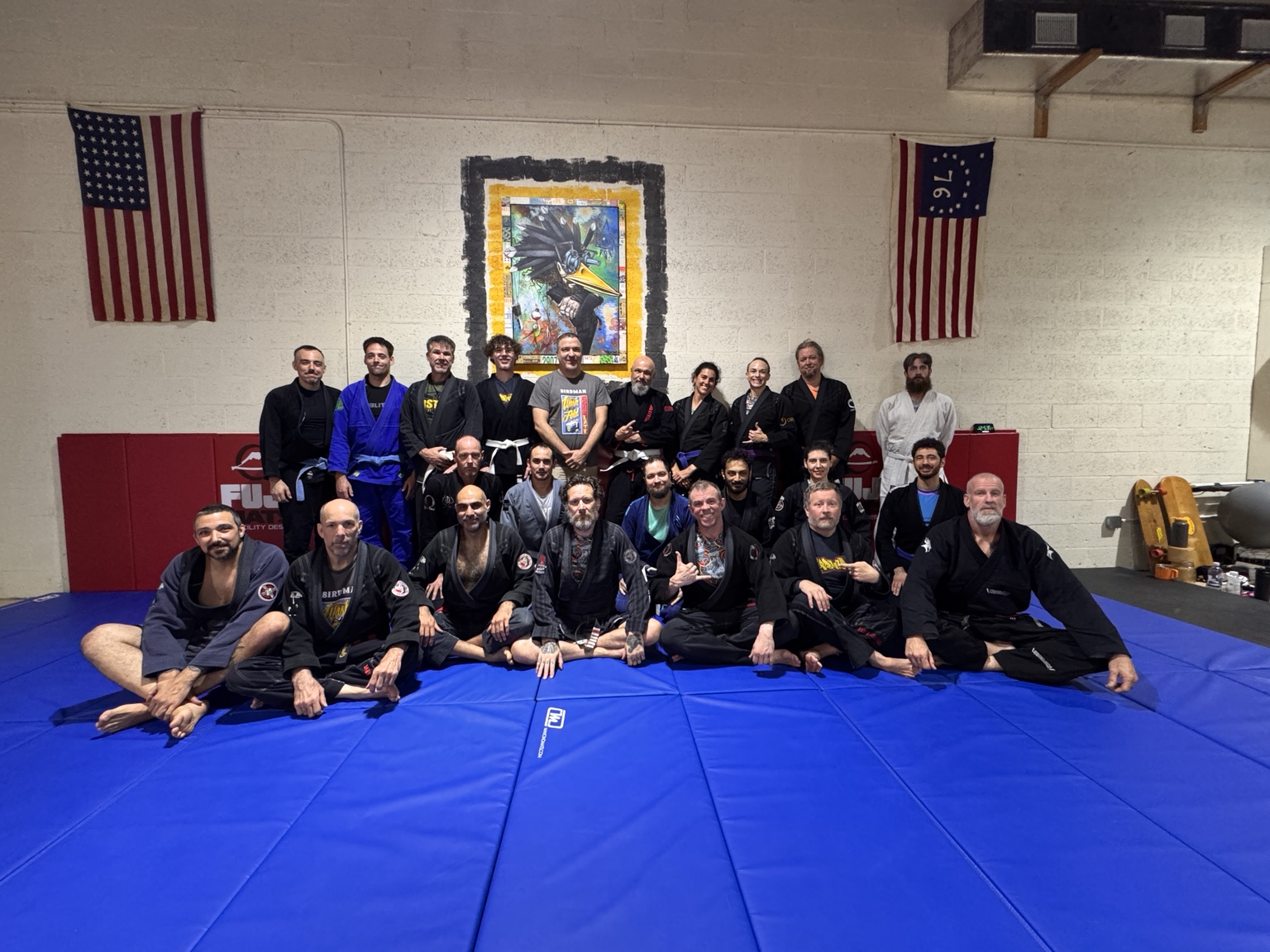 Students and instructors gathered on the mats at Birdman’s Wash N’ Fold