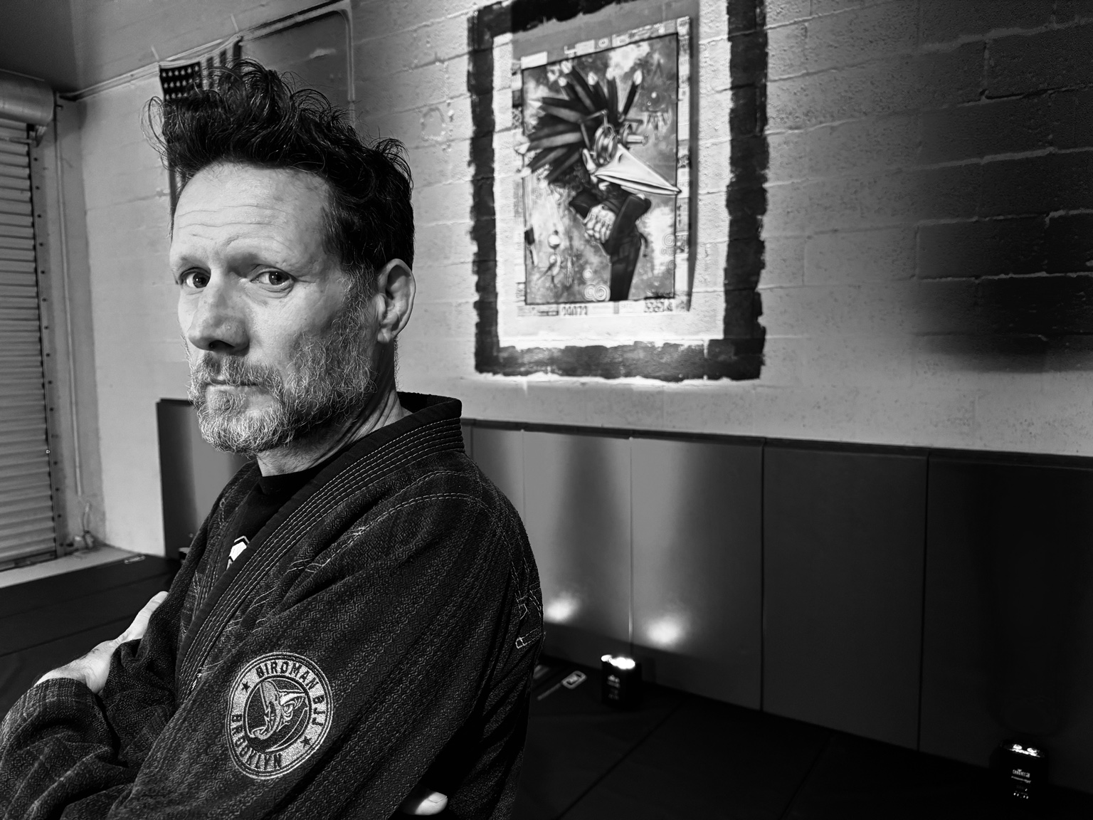 Black-and-white portrait of John Finn in his gi at Birdman’s Wash N’ Fold